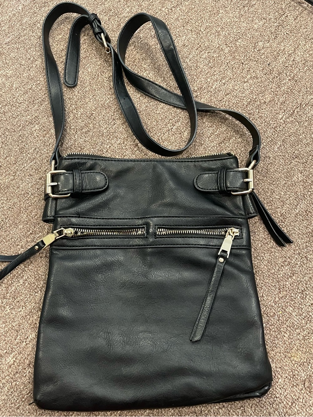 Miztique faux leather crossbody bag with adjustable strap.